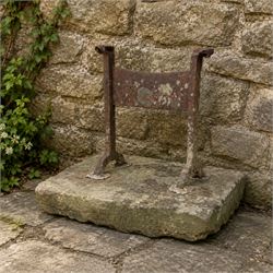 19th century cast iron boot scraper, mounted on a rectangular hewn stone slab base, with s...