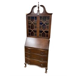Early 20th century mahogany bookcase bureau, broken swan neck pediment over two glazed cupboard doors enclosing two shelves, fall front top concealing pigeonholes over three drawers 