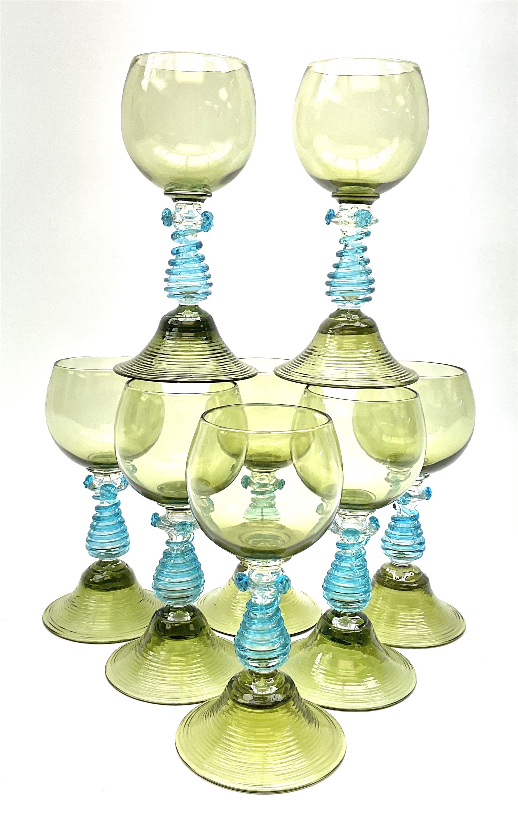 A set of eight German green glass hock glasses, with trailed spiral and