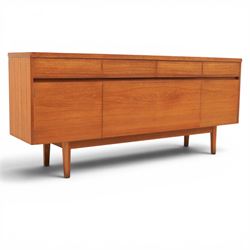 Mid-20th century teak sideboard, rectangular top above four frieze drawers with recessed handles, flanked by two cupboard doors with fall front central media cupboard
