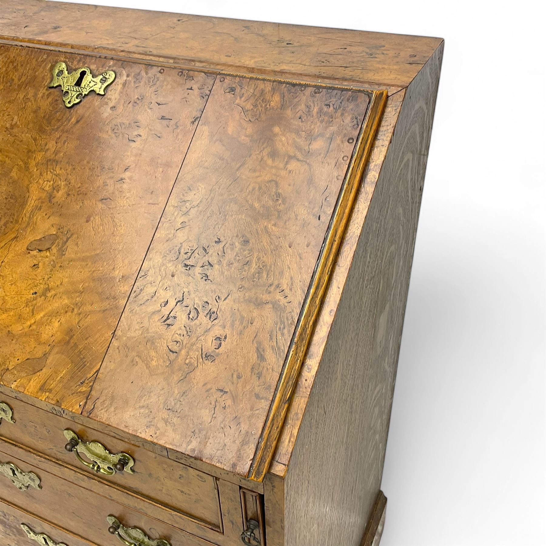 George III figured walnut bureau, fall-front enclosing central cupboard, six pigeonholes and six drawers, fitted with four graduated cockbeaded drawers, on bracket feet
