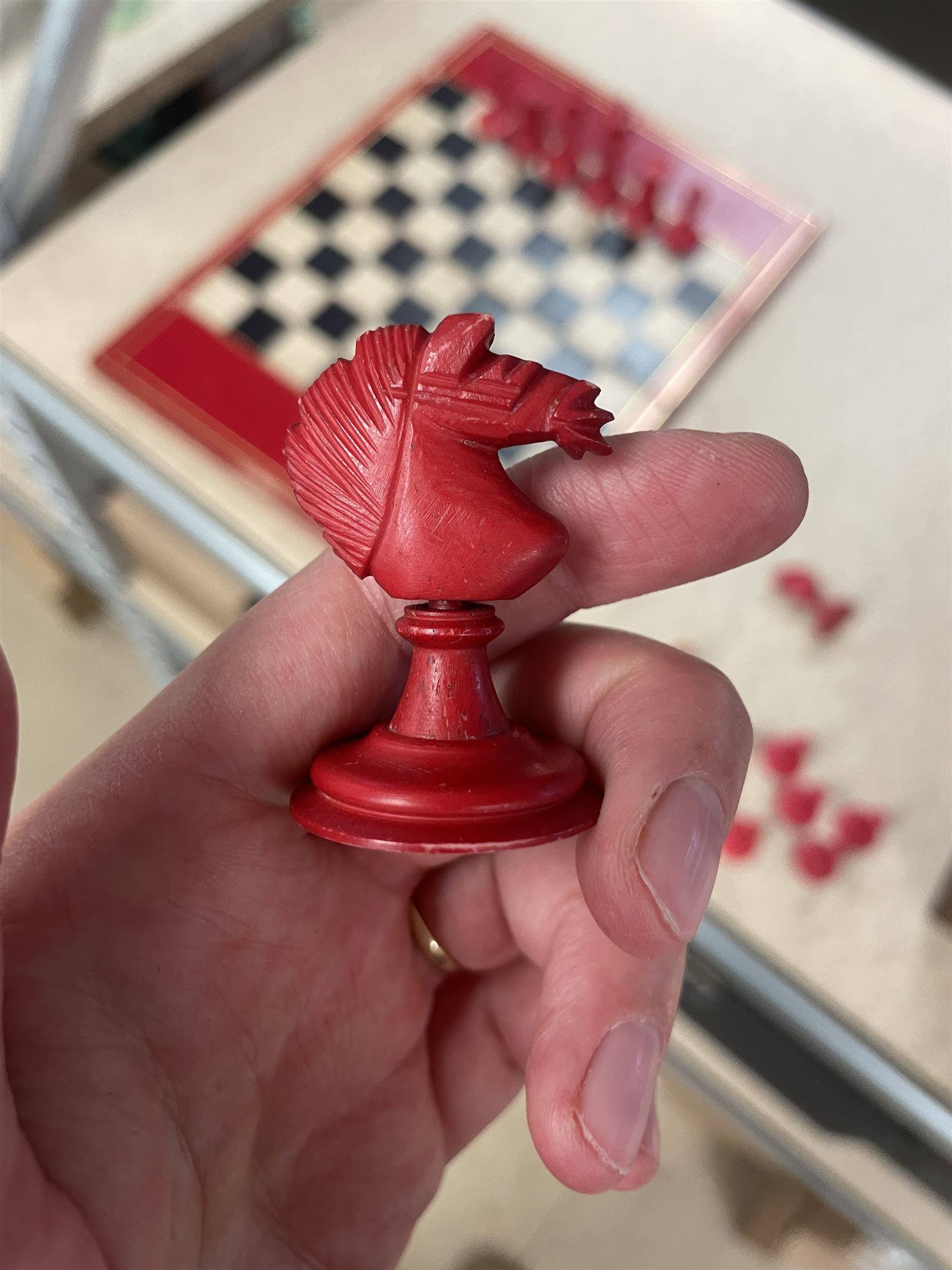 19th century walnut and brass bound games compendium box, painted to enhance the grain, of rectangular form, the hinged opening cover with rounded sides, central brass cartouche with engraved lion crest, and brass riveted straps, opening to reveal a red leather and blue silk lined compartmented interior, with fold-down games board, and lift-out tray containing playing cards, ebony turned dice towers, white and red stained bone draughts, and chess pieces, ivory dice, and ivory and ebony whist markers, and brass bezique board, cribbage board and markers, H15cm W32cm D24cm
This lot has been registered for sale under Section 10 of the APHA Ivory Act