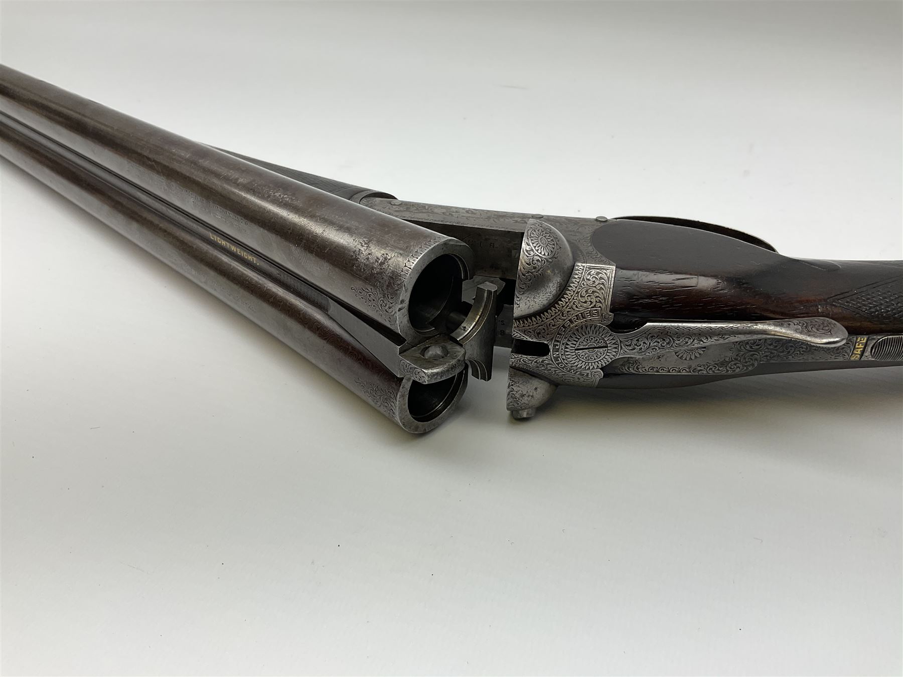 Lincoln Jeffries 12-bore side-by-side double barrel lightweight boxlock non-ejector sporting gun,  out-of-proof 66cm damascus barrels with sunken ribs, profusely engraved action, Prince of Wales walnut stock with chequered pistol grip and fore-end and thumb safety, sling swivels under barrel and stock, serial no.2139(?), L107.5cm overall RFD ONLY