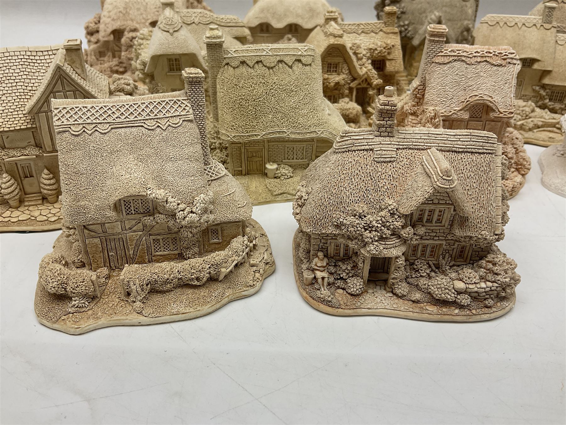 Twenty-three Lilliput Lane models from the Paint Your Own collection, to include Catmint Cottage, Sugar and Spice, Gypsy Cottage, Ruby Cottage and Little Birch, some boxed
