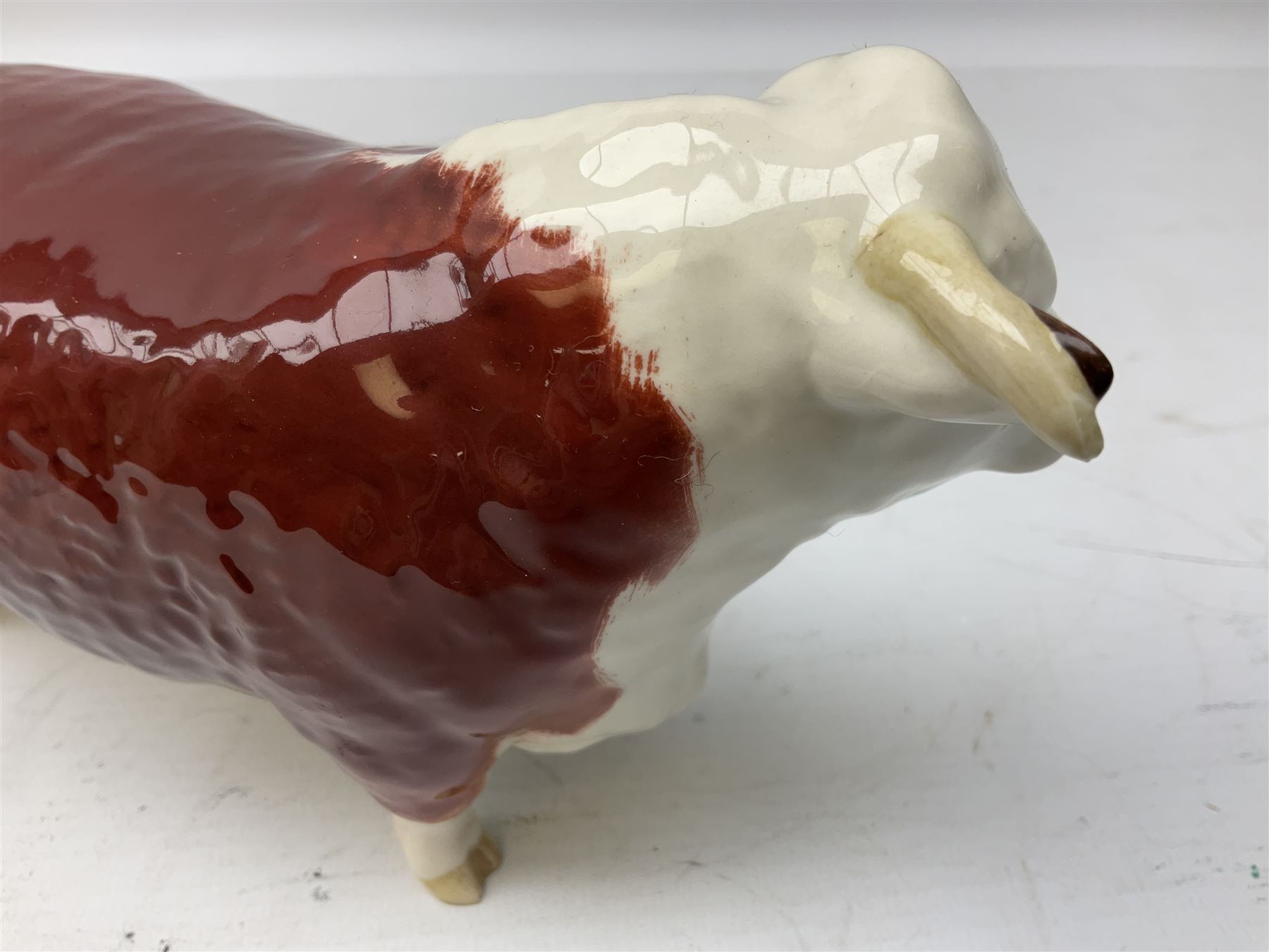 Three Beswick models comprising Hereford Bull no 949, 'CH Cutmil Cupie' Pug, and bay Shire horse, all with printed marks beneath