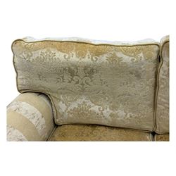 Contemporary two-seat sofa, upholstered in damask fabric with a pale gold floral pattern, rolled arms with covers, loose back and seat cushions, on matching skirted base with concealed castors