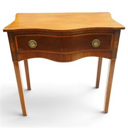 Ealy 19th century Sheraton design inlaid mahogany serpentine-fronted side table, shaped rectangular top with boxwood-inlaid edge, fitted with singe cock-beaded frieze drawer with satinwood cross-banding and herringbone stringing, fitted with original pressed brass octagonal handle plates, flanked by oval feather motif inlays, raised on square tapering supports