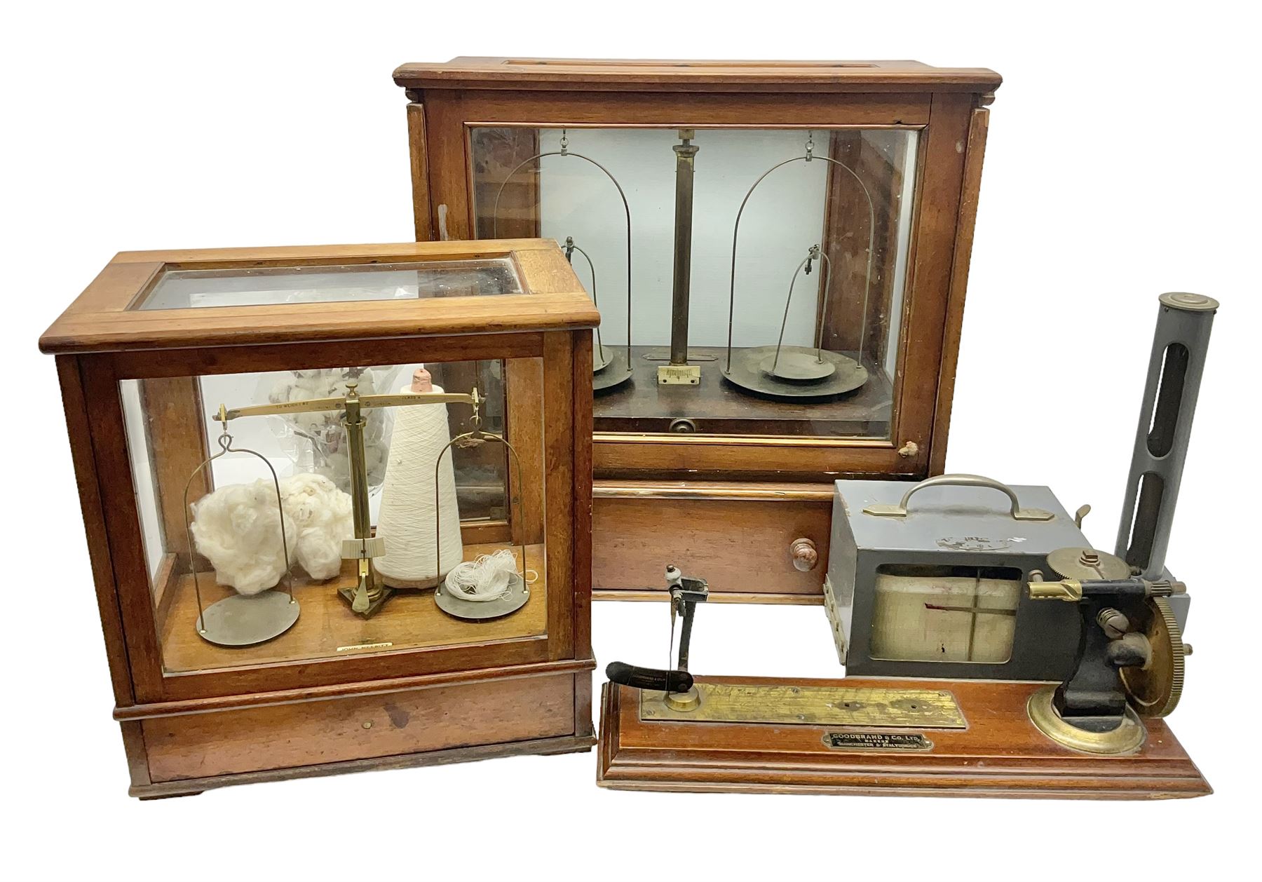 Collection of textile equipment, comprising, Goodbrand & Co. mahogany and brass yarn tester, Negretti & Zambra barograph and two sets of precision scales
