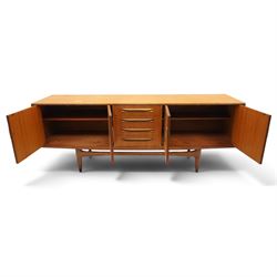 G-Plan - 'Fresco Long John' teak mid 20th century sideboard, a central bank of four drawers, flanked by twin cupboard doors, with recessed handles, on a tapering supports 