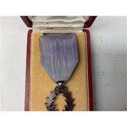 Five continental medals - WW1 Belgian Cross of Fire; WW1 French Croix De Guerre; French Croix De Combattant; French Republic Workers silver merit awarded to L. Mounet 1950; and boxed French Palmes Universitaires Officier d'Academie silver and enamel wreath (5)