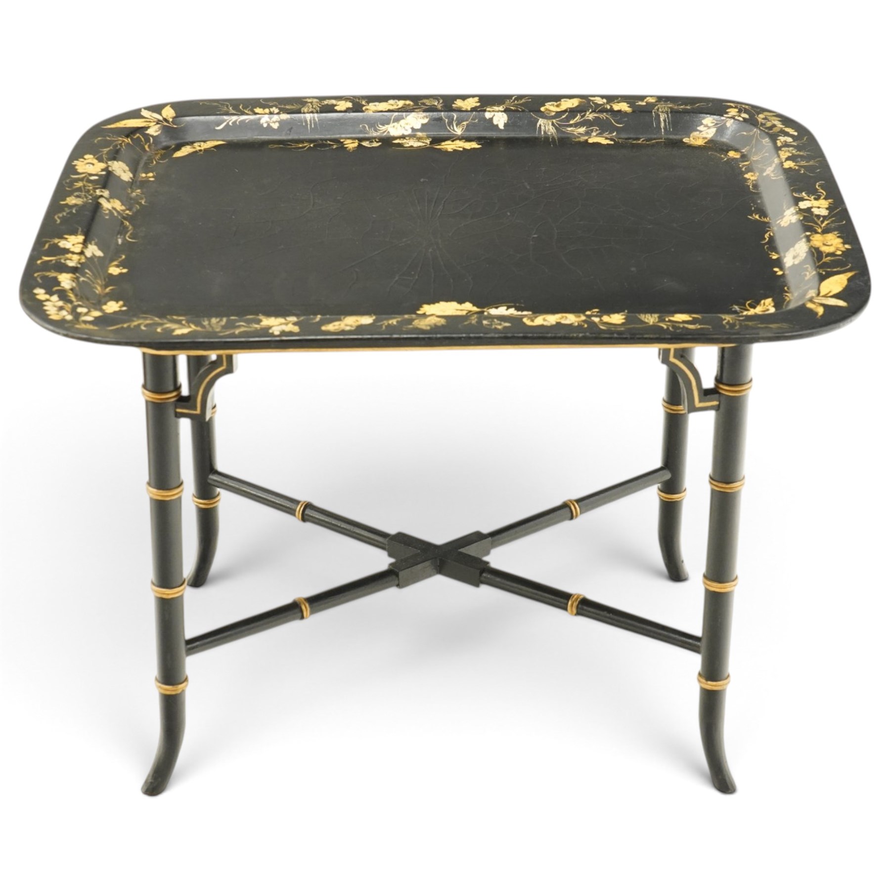 Victorian ebonised and gilt-painted papier-mâché tray on later ebonised and parcel-gilt simulated bamboo stand, the rectangular removable tray with gilt foliate and butterfly scenes with scrolling branches, the base on four ring-turned and splayed supports united by X-stretcher