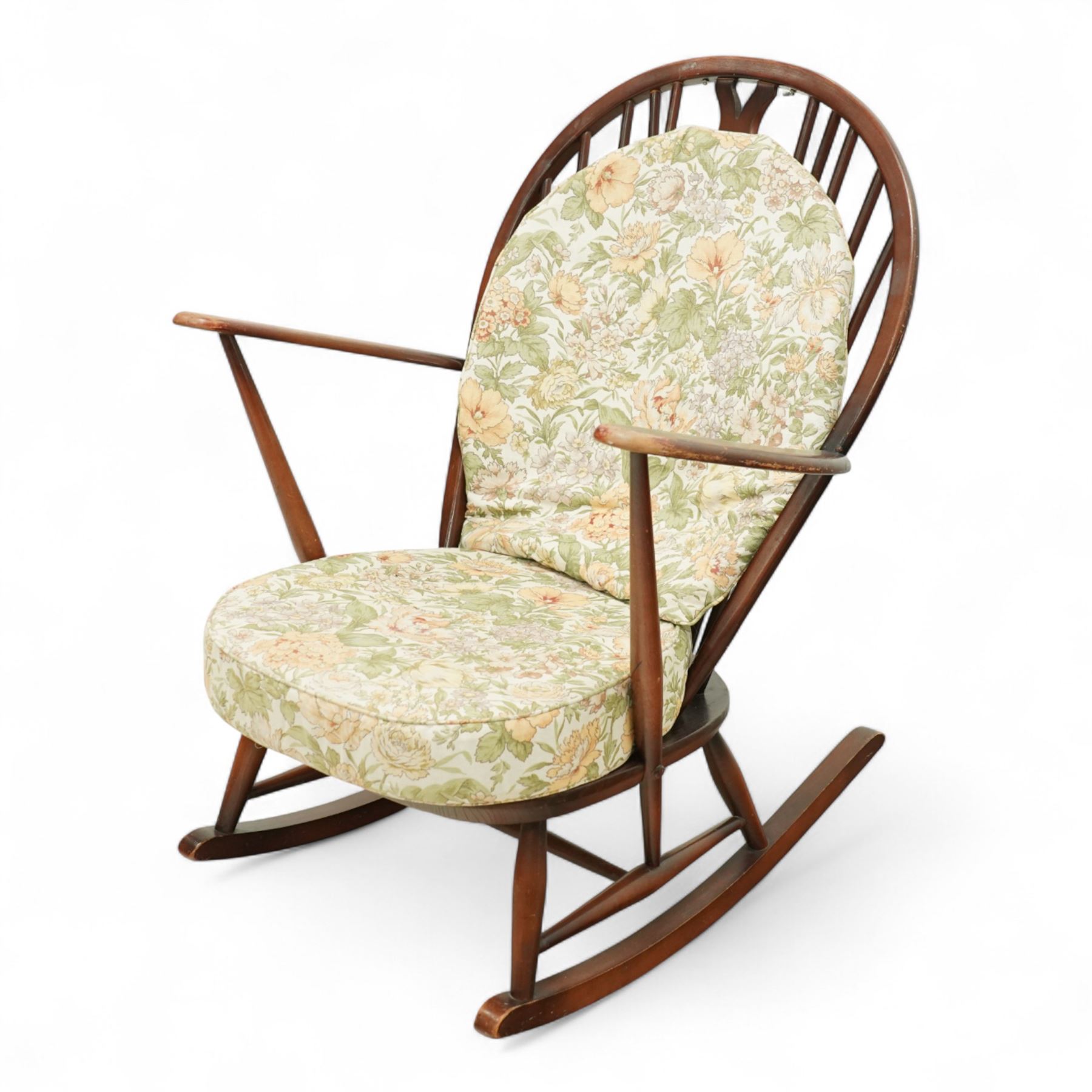 Ercol - Mid-20th century ‘Fleur-de-Lis’ rocking chair, elm and beech frame with curved arms, pierced back crest and stick supports, floral upholstered seat and back cushions, on curved rockers