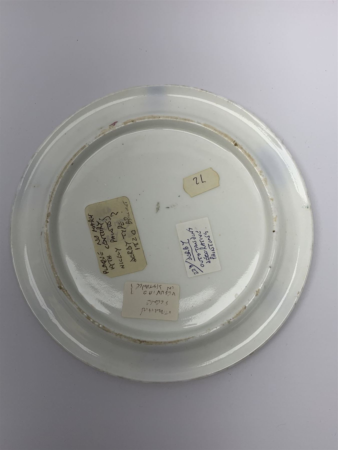 19th century porcelain stand, of circular form, in the Derby style, hand painted with a ruinous column and roses against a landscape background, within a gilt border, D7cm