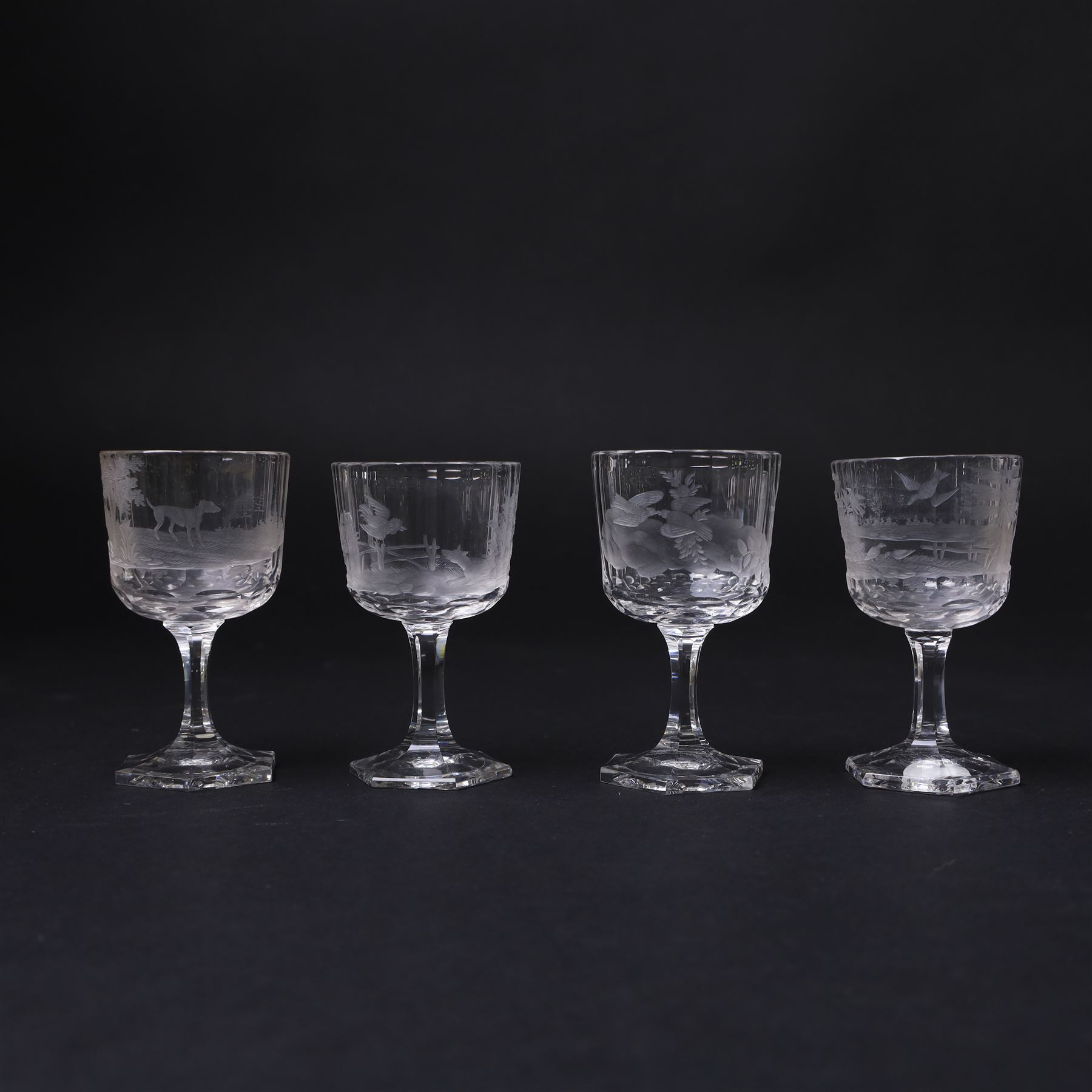 Set of four Galle, Nancy, intaglio engraved liqueur glasses, Gallé, Nancy, circa 1880, each with faceted bucket bowl engraved with animals within landscape settings, two examples engraved 'Galle Reinemer a Nancy', one engraved 'Galle a Nancy', and one unsigned, H7cm, together with a small Bohemian Art Deco amber overlaid glass decanter with stopper and two glasses, decanter H17cm