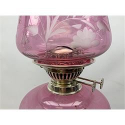 Victorian silver plated oil lamp, the square stepped base leading to a Corinthian column supporting ruby glass reservoir, burner, clear glass chimney and foliate etched ruby glass shade, H81cm