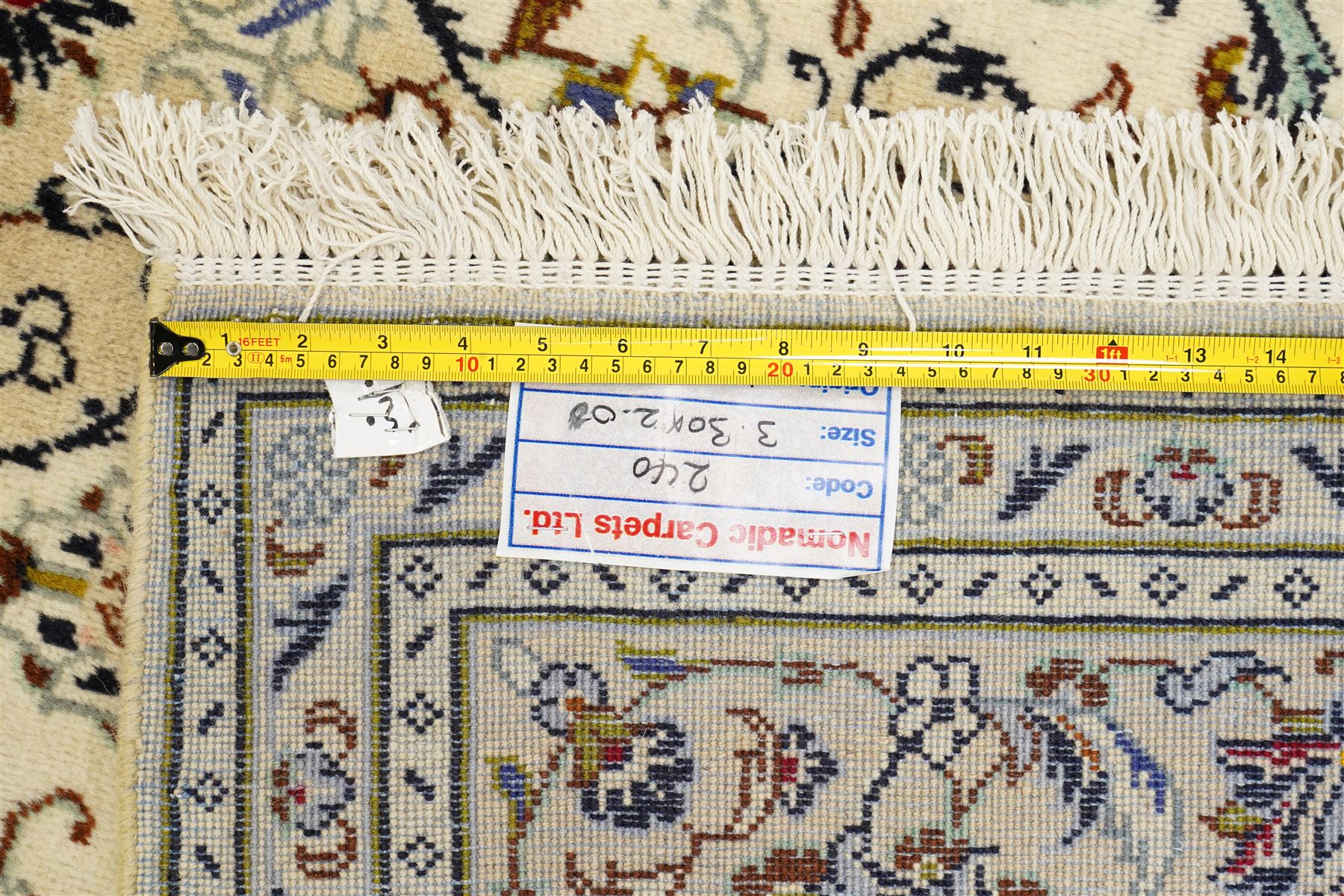 Central Persian Kashan hand-knotted carpet, ivory field with central lobed medallion issuing an all-over design of scrolling vines, palmettes, and floral sprays, within conforming spandrels, enclosed by a foliate border, framed by multiped guard stripes, with cotton fringe ends 