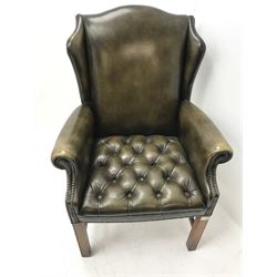 Georgian style wing back armchair upholstered in deep buttoned and studded green leather, square supports 