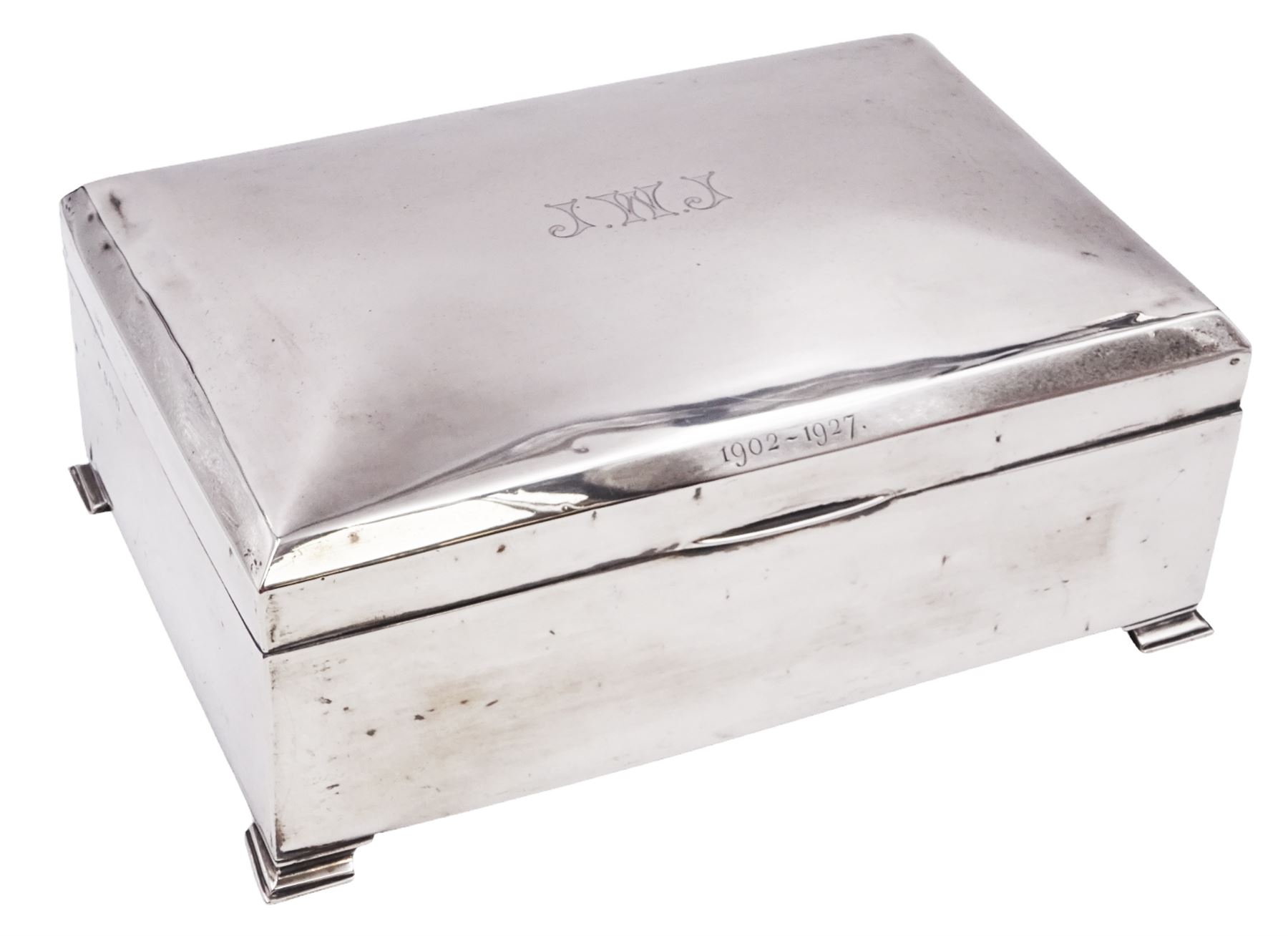 1920s silver mounted presentation cigarette box, of rectangular form, with engraved initials J.W.J and dated 1902-1927 to slightly domed hinged cover, opening to reveal compartmentalised softwood interior, upon four bracket feet, hallmarked Birmingham 1920, maker's mark worn and indistinct, H9cm, W23cm, reputedly given to John William Johnson, father of Amy Johnson,  famous for being the first long distance (to Australia) solo female pilot, and first female British grounds engineer, for his silver wedding anniversary