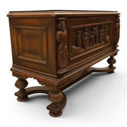 Carved oak coffer bench, rectangular moulded top above carved fall front, with figural, mask and foliate decoration, panelled sides, raised on turned bun feet with shaped lower apron