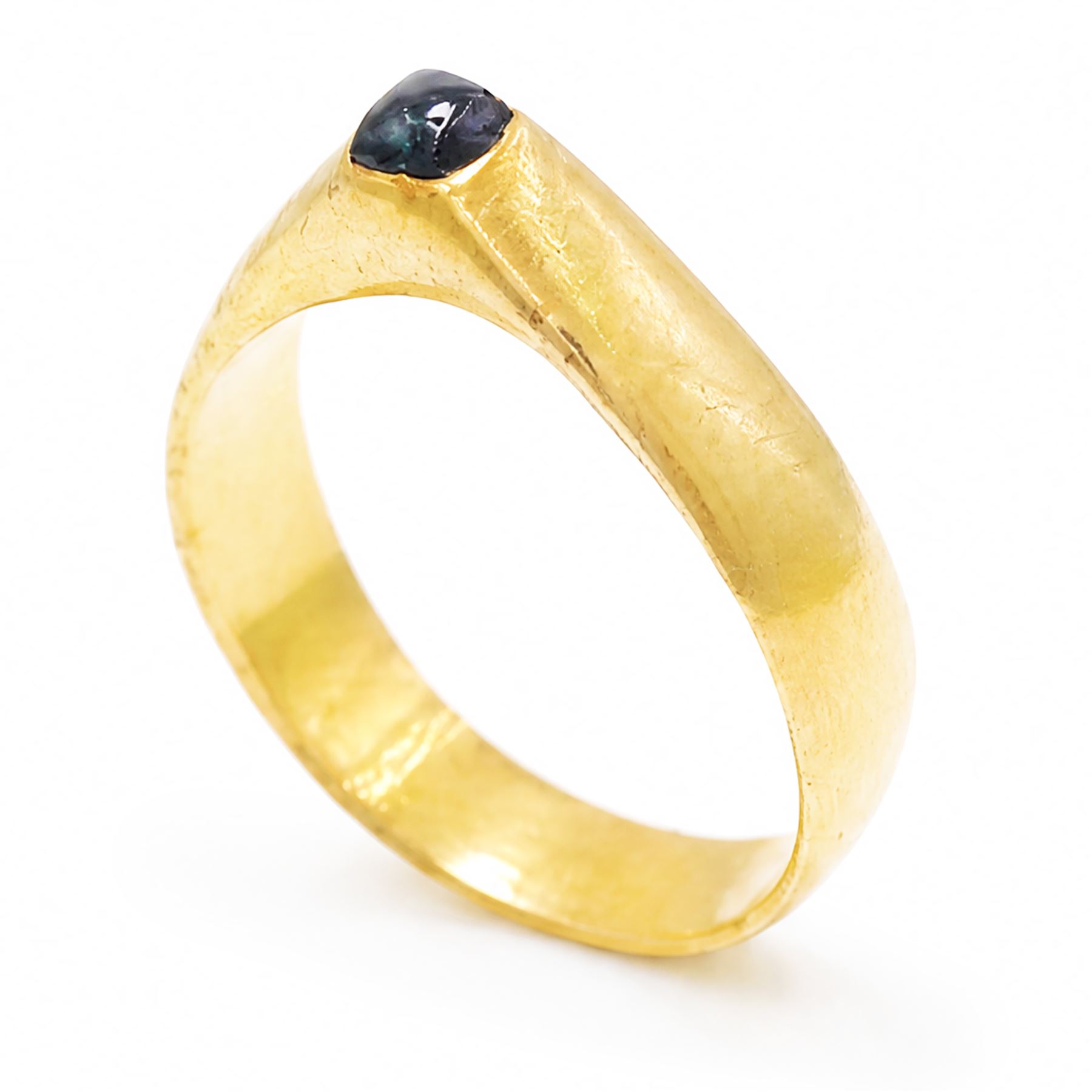 Medieval gold sapphire stirrup ring, circa. 1150-1500, the hoop of ‘D’ shaped cross-section, with raised triangular shaped bezel centred at the apex with a cabochon sapphire