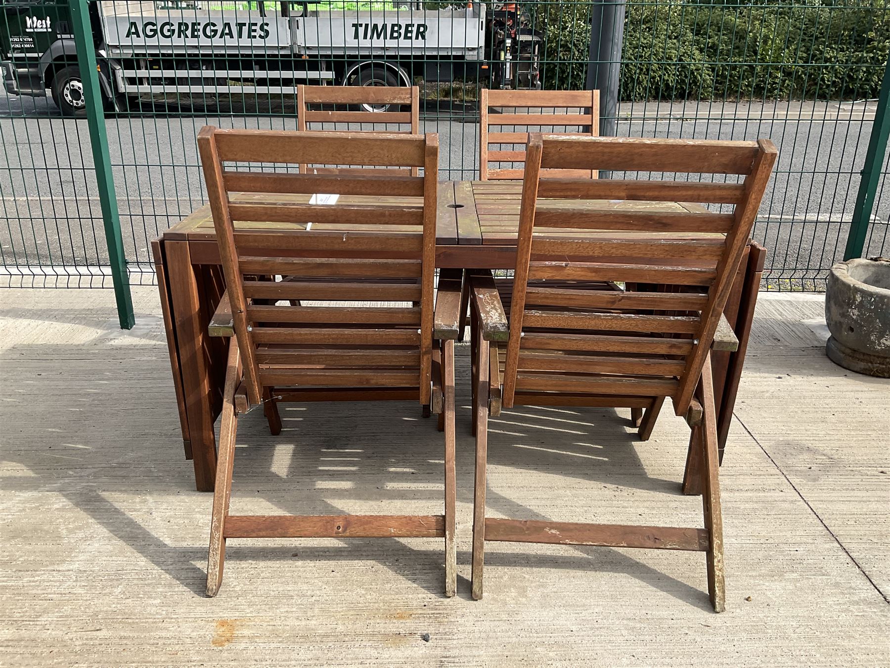 Rectangular teak drop leaf garden table, and four slatted armchairs