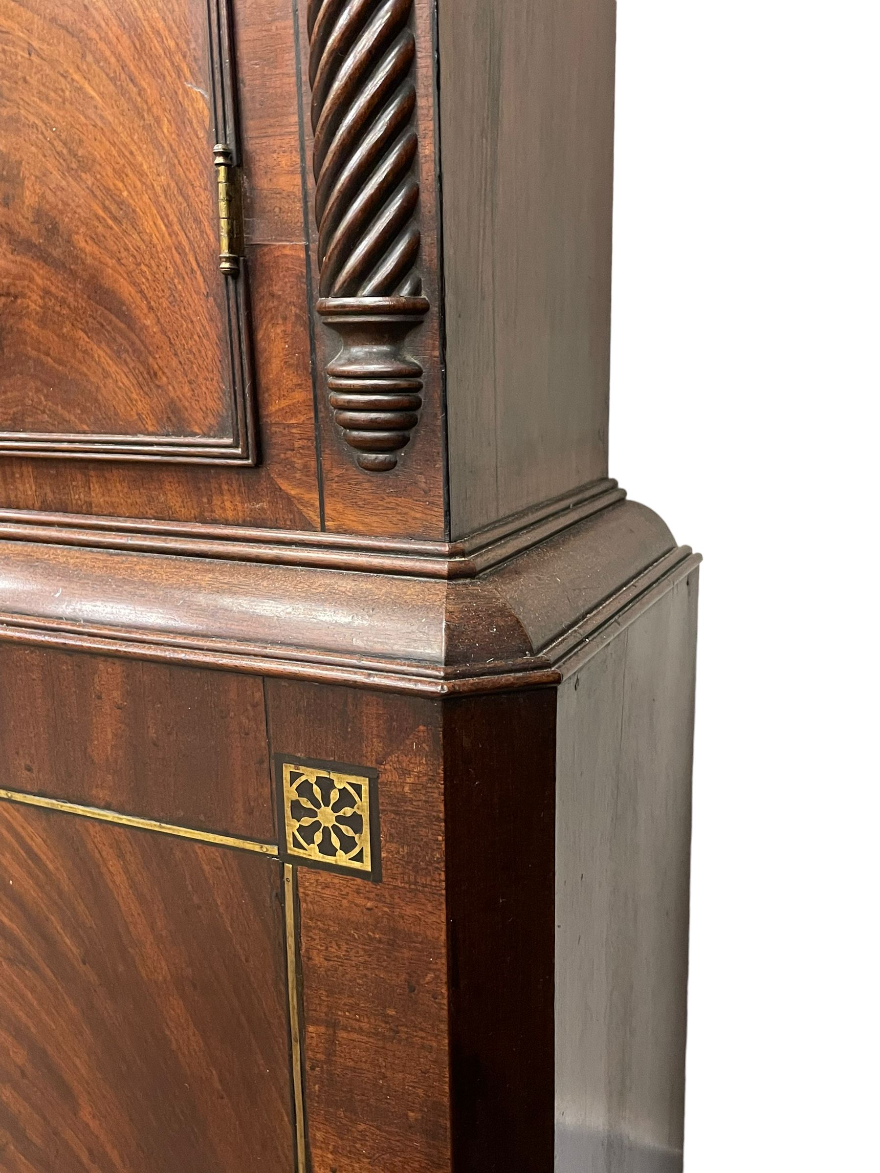 Nathaniel Dumville of Stockport - 8-day brass inlaid mahogany longcase clock c1840, swans neck pediment with ball and spire finials and wooden paterae, recessed break arch hood door flanked by rope twist pilasters, trunk with conforming pilasters and gothic ogee topped door, canted plinth raised on bracket feet, fully painted break arch dial with moon work and spandrels depicting the four seasons, centre with Roman numerals, minute track, subsidiary date and seconds dials, matching stamped brass hands, four pillar movement with an anchor escapement, rack striking on a bell. With weights and pendulum.
The Dumville family were prevalent Cheshire clockmakers working in Stockport 1820-42.
