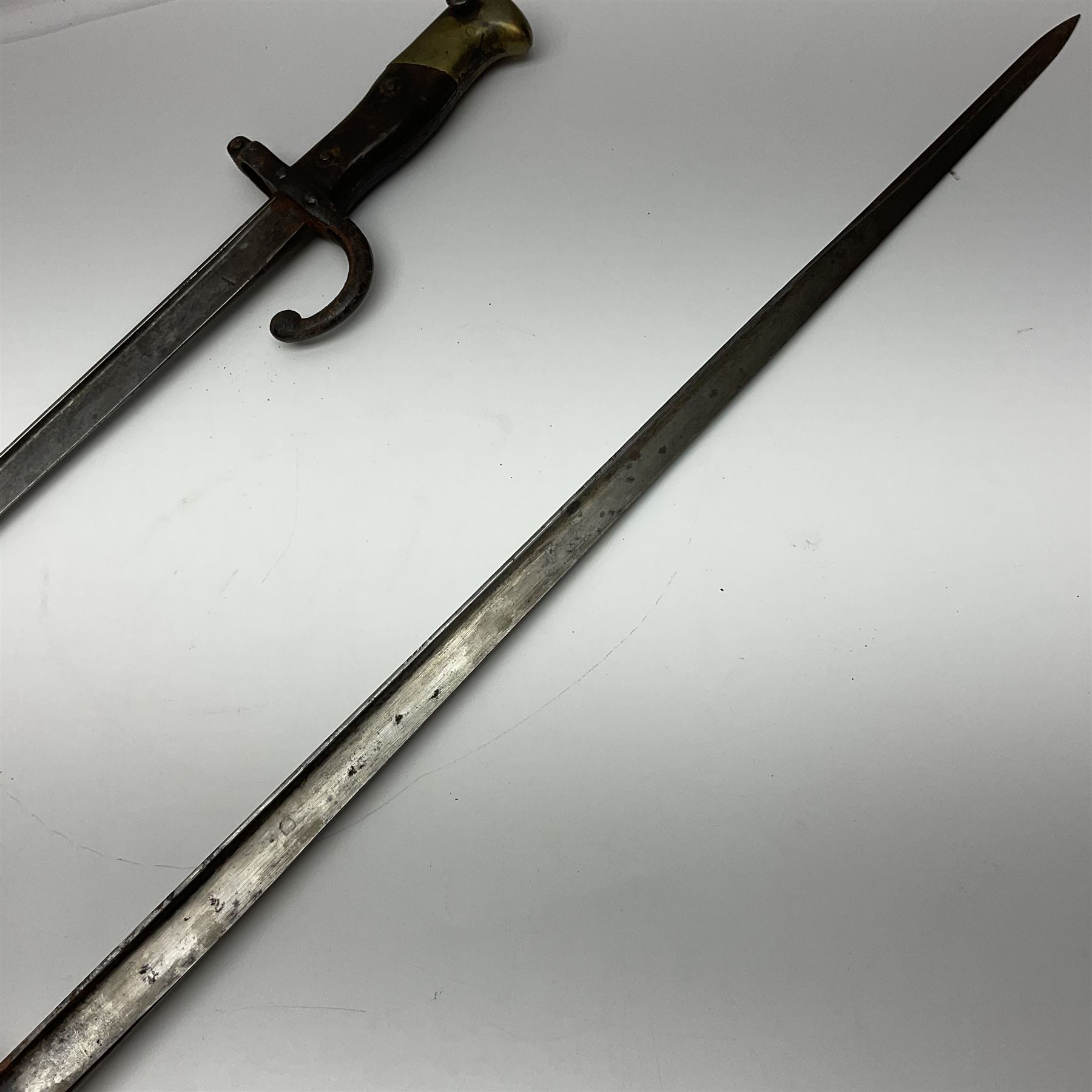 Two 19th century French model 1874 epee bayonets, each with 52cm steel blade, and armoury dates for 1880 and 1881 L64cm overall (2)