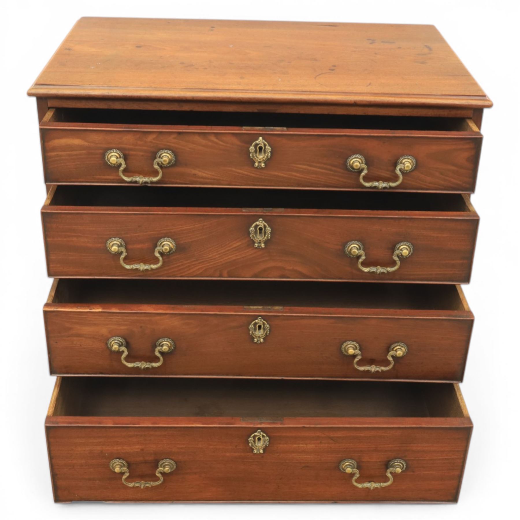 Georgian mahogany dwarf chest of drawers, the moulded rectangular top over four graduated drawers, fitted with brass drop handles, upon shaped bracket feet