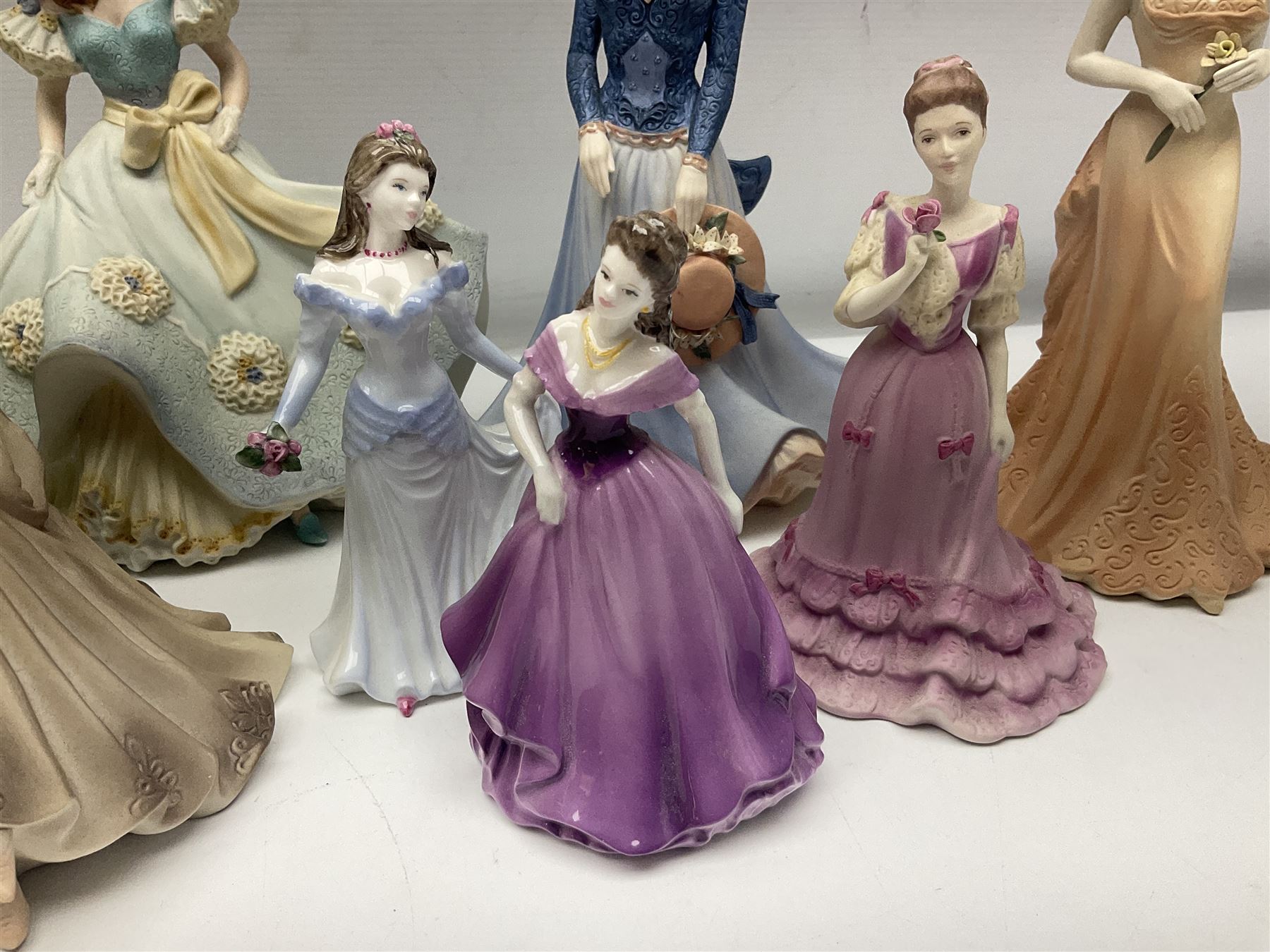 Eight Coalport figures of ladies, comprising five Age of Elegance examples to include Richmond Park, Summer Saunter and Touch of Spring, together with Beau Monde Isobel 1998, Valentine Debutante Eternity and Devotion