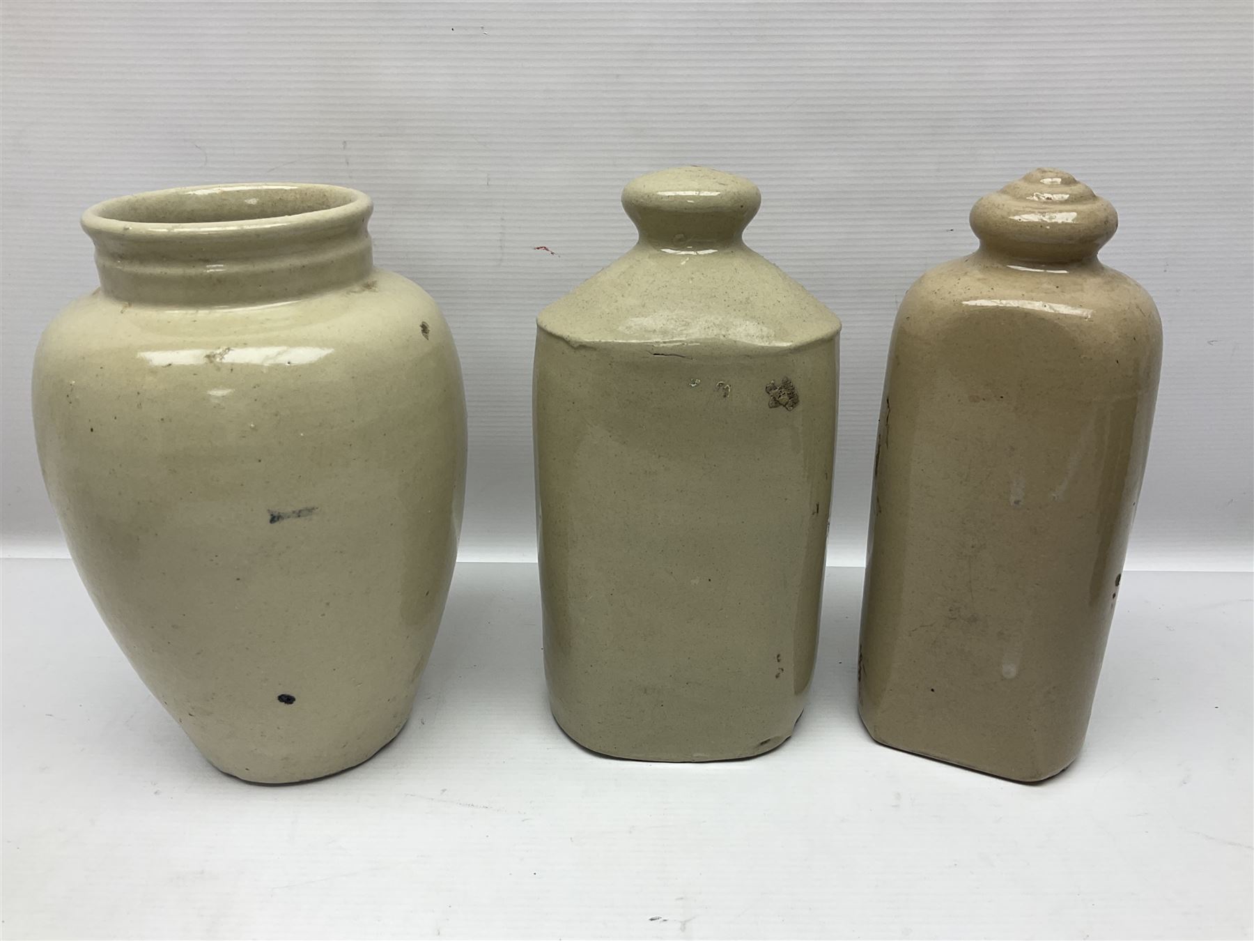 Virol bone marrow stoneware jar, two stoneware hot water bottles and a collection of small apothecary bottles to include amber and green glass examples, some with stoppers and labels, jar H24cm