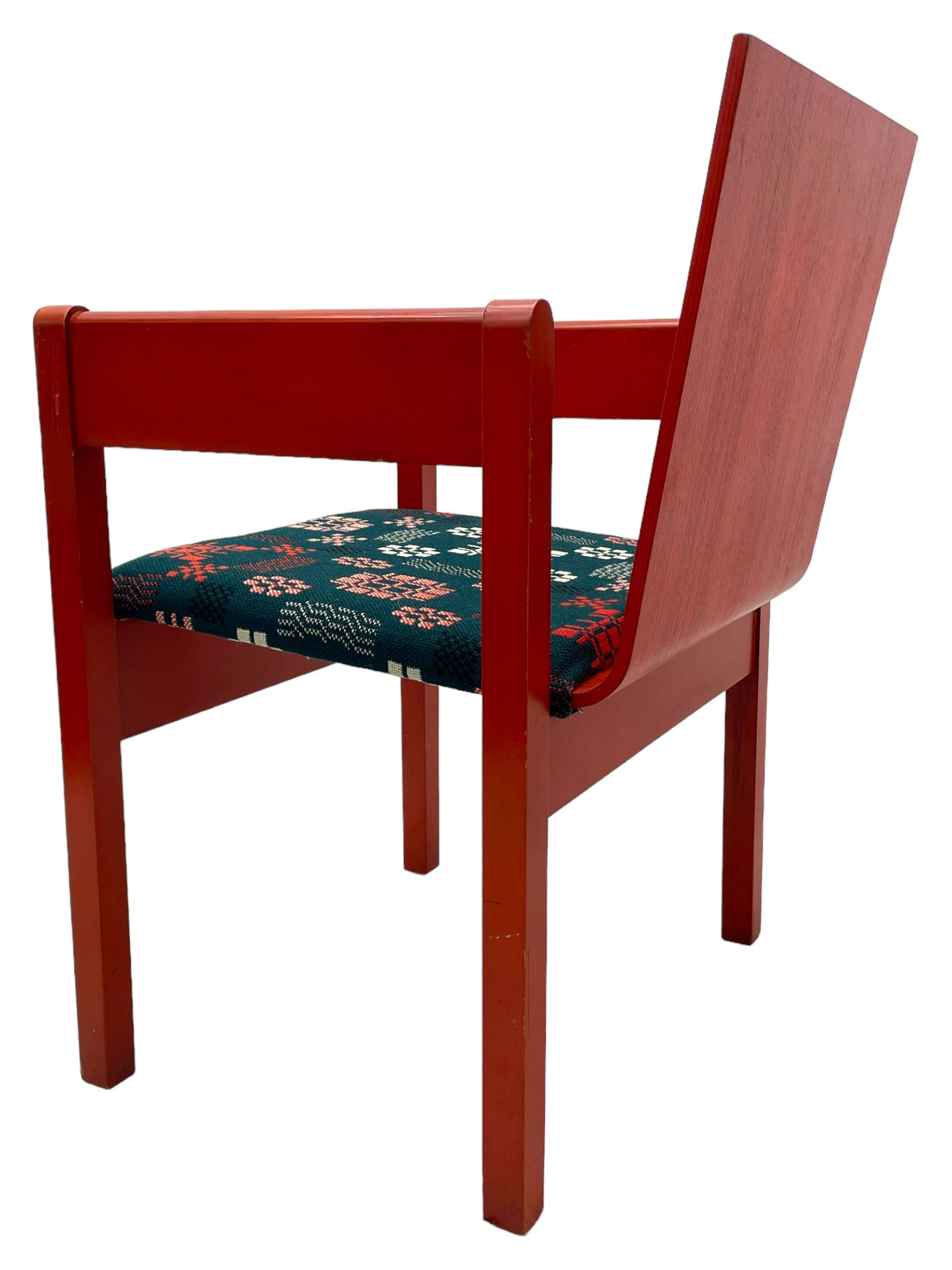 Prince Charles Investiture Chair - designed by Lord Snowdon, manufactured by Remploy, 1969, red finish and decorated with the Prince of Wales's feathers and moto 'Ich Dien' in gilt, later upholstered seat in 1950s design Welsh blanket weave fabric 