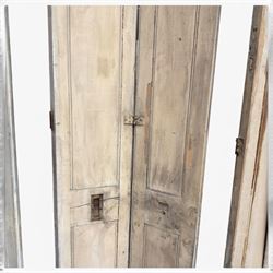 Set of three French 19th century painted pine folding window shutters of tall form, each comprising two hinged leaves with three graduated raised and fielded panels, in antique cream-painted finish