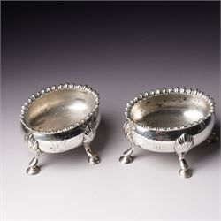 Pair of early George III silver oval salts with moulded rims and on four shell moulded sup...