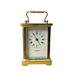 Taylor & Bligh - English 8-day carriage clock in a corniche-style case, white dial with roman numerals and steel moon hands, 11 jewel movement with a lever platform escapement. With key.