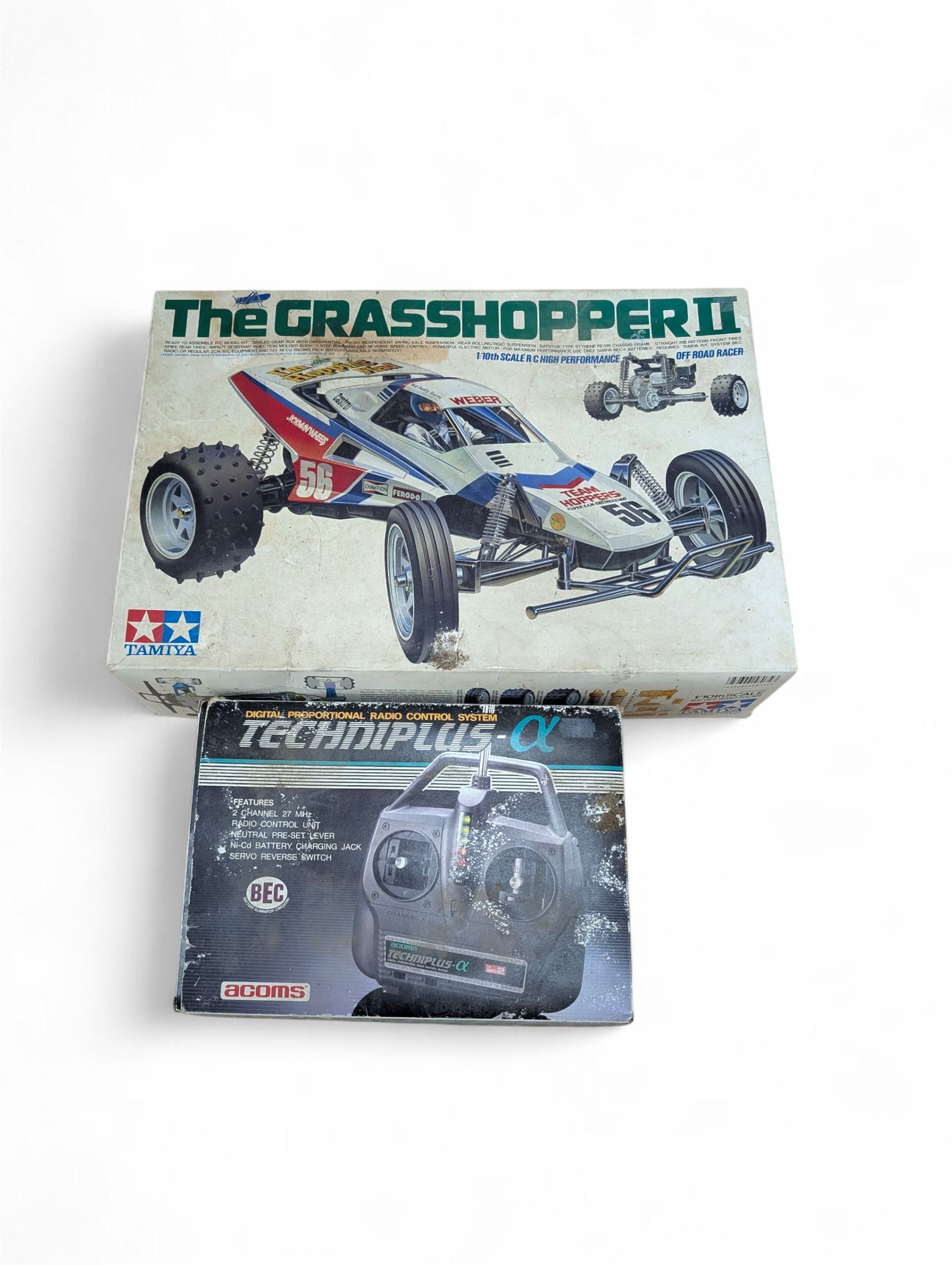 Tamiya 'The Grasshopper' 1:10 scale remote control car, boxed, together with an Acombs Techniplus-a controller, both boxed