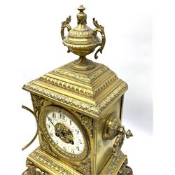 French gilt metal mantle clock c1900, the domed case surmounted by an urn with rococo swags, with circular side handles on a spreading base with four splayed feet, dial bezel with an egg and dart slip, enamel dial with an applied pierced gilt centre, gothic Arabic numerals, minute markers and steel fleur-de-lis hands, with an eight-day twin barrel countwheel striking movement, striking the hours and half hours on a bell. On a rectangular gesso plinth with velvet pad. With pendulum.


