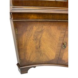 Georgian design mahogany concaved corner cabinet, projecting dentil cornice over two astragal glazed doors, double cupboard below, on bracket feet