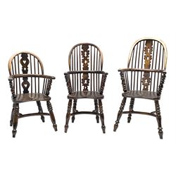 Matched set of three graduating miniature elm and beech Windsor armchairs, pierced fretwork splat and stick back, turned supports joined by crinoline stretchers