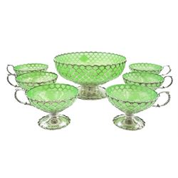 1930's silver dessert service, comprising openwork pedestal bowl with fan shaped piercing to the bowl, upon a spreading circular foot with lobed rim, and six pedestal cups of conforming design with capped scroll handles, each with lime green glass liner, hallmarked Mappin & Webb Ltd, Sheffield, the bowl dated 1937, the cups 1938, bowl H11cm D22cm, approximate total weight excluding glass liners 37 ozt (1151 grams)
