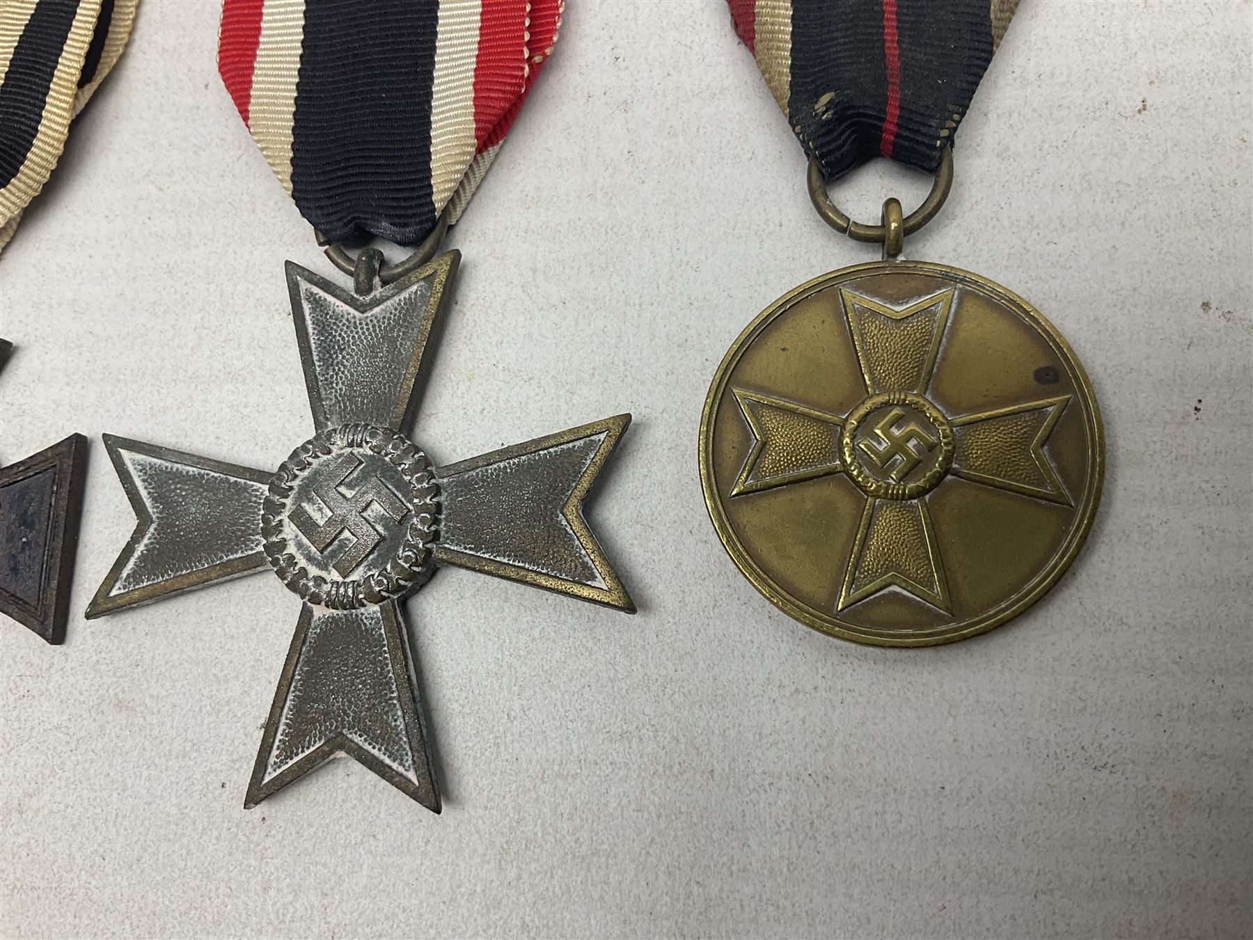 Two WW1 German medals - copy Cross of Honour with swords (combatants); Cross of Honour without swords (non-combatants); and two WW2 German medals - War Merit Medal; and War Merit Cross; all with ribbons (4)