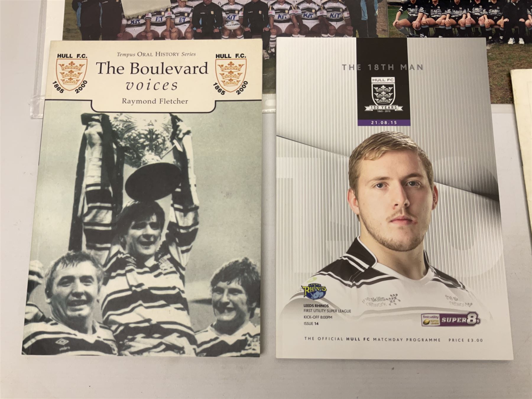 Hull F.C. memorabilia; Clive Sullivan 1986 memorial game programme, Open Evening 1994 programme with multiple player signatures, 'Old Faithful' 45rpm record, Wembley rosettes, 2000 team poster with facsimile signatures, framed print 'Farewell to the Boulevard 1895-2002', fully signed team photograph, various booklets, CD, DVD etc; and a folder containing the Merlin Rugby League card collection