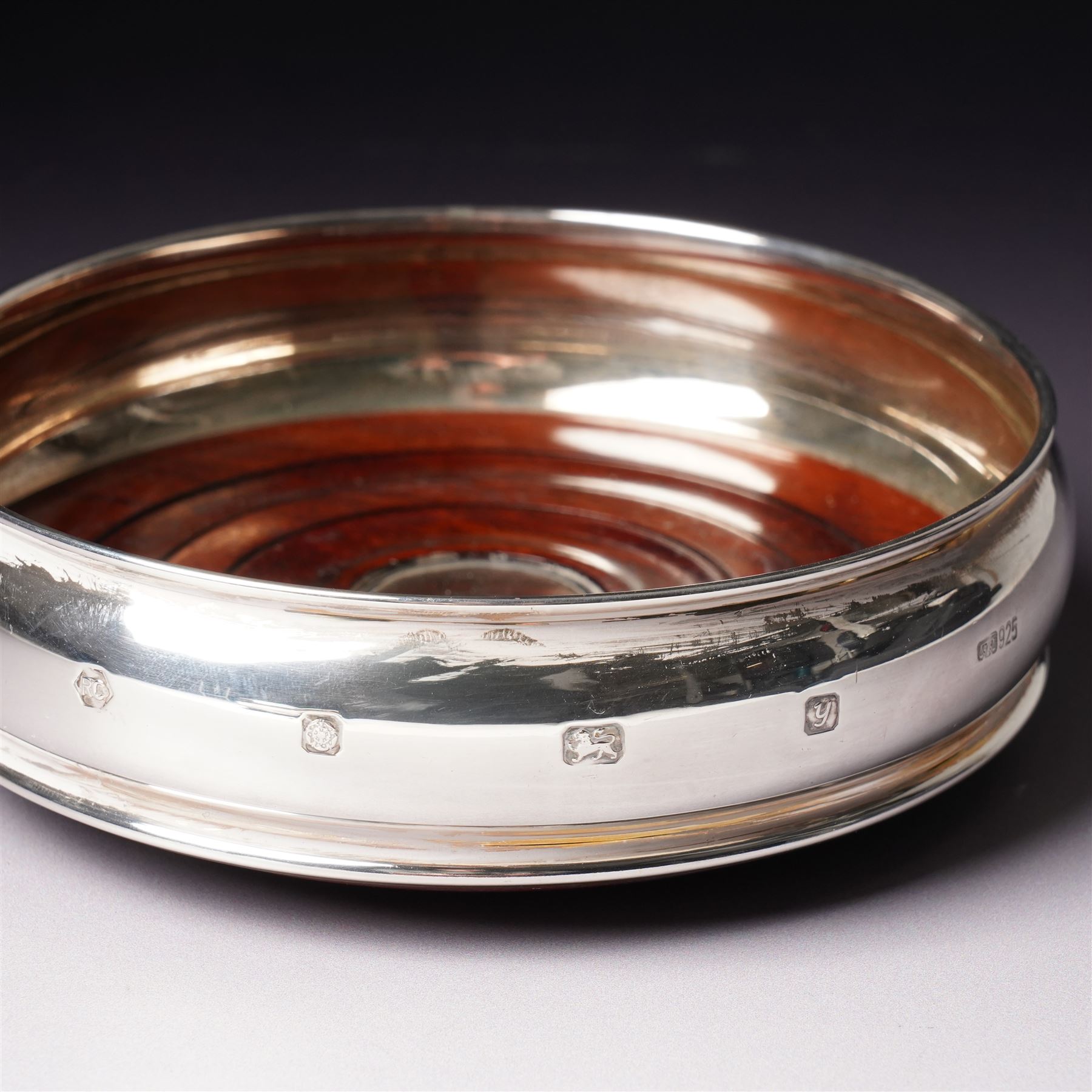 Pair of silver bottle coasters with turned wooden bases D12cm Sheffield 1998 Maker Carr's of Sheffield 
