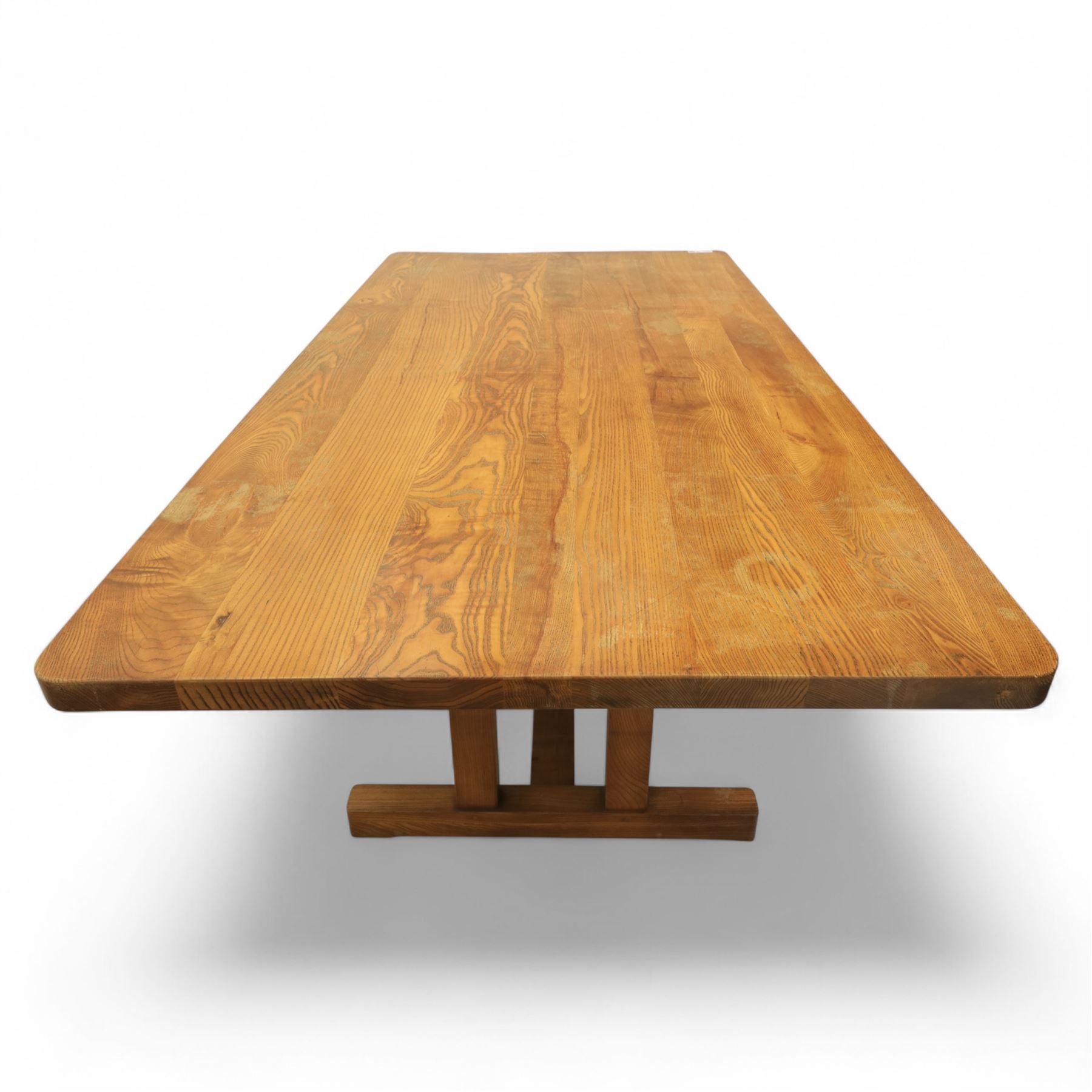 Treske of Thirsk - solid oak refectory dining suite, rectangular top with chamfered edge over trestle base united by a central stretcher, together with six matching slat back dining chairs, including two carvers, with panelled seats and square legs united by stretchers (H 87cm, W 62cm, D 57cm)