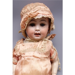  German bisque head doll with applied hair, sleeping eyes, open mouth with teeth and tongue, and composition body with jointed limbs, marked 'P.M 914 Germany 14'  H63cm  