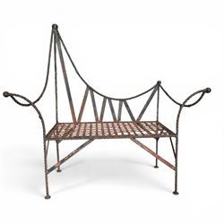 Victorian design wrought iron garden bench, with asymmetrical rope-twist frame, arched back and sides over out-swept arm terminals with ball finials, flanking a lattice seat, in antique black-painted weathered finish