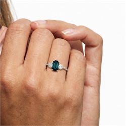 Platinum green tourmaline and diamond three stone ring, single octagonal cut tourmaline of 1.54 carat, with a single round brilliant cut diamond set either side, stamped Plat 950, total diamond weight 1.06 carat