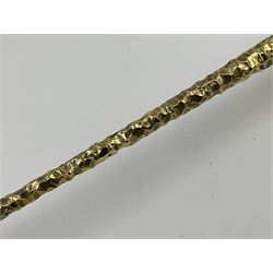 Pair of modern silver candlesticks by Stuart Devlin, the tapering parcel gilt stems with signature textured detailing, each supporting a fluted candle holder and upon a spreading circular foot, hallmarked Stuart Devlin, London 1973, H25cm