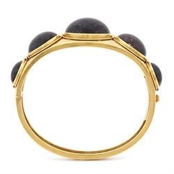 Victorian gold banded agate hinged bangle, set with five graduating cabochon cut agates, surrounded by wirework and bead decoration