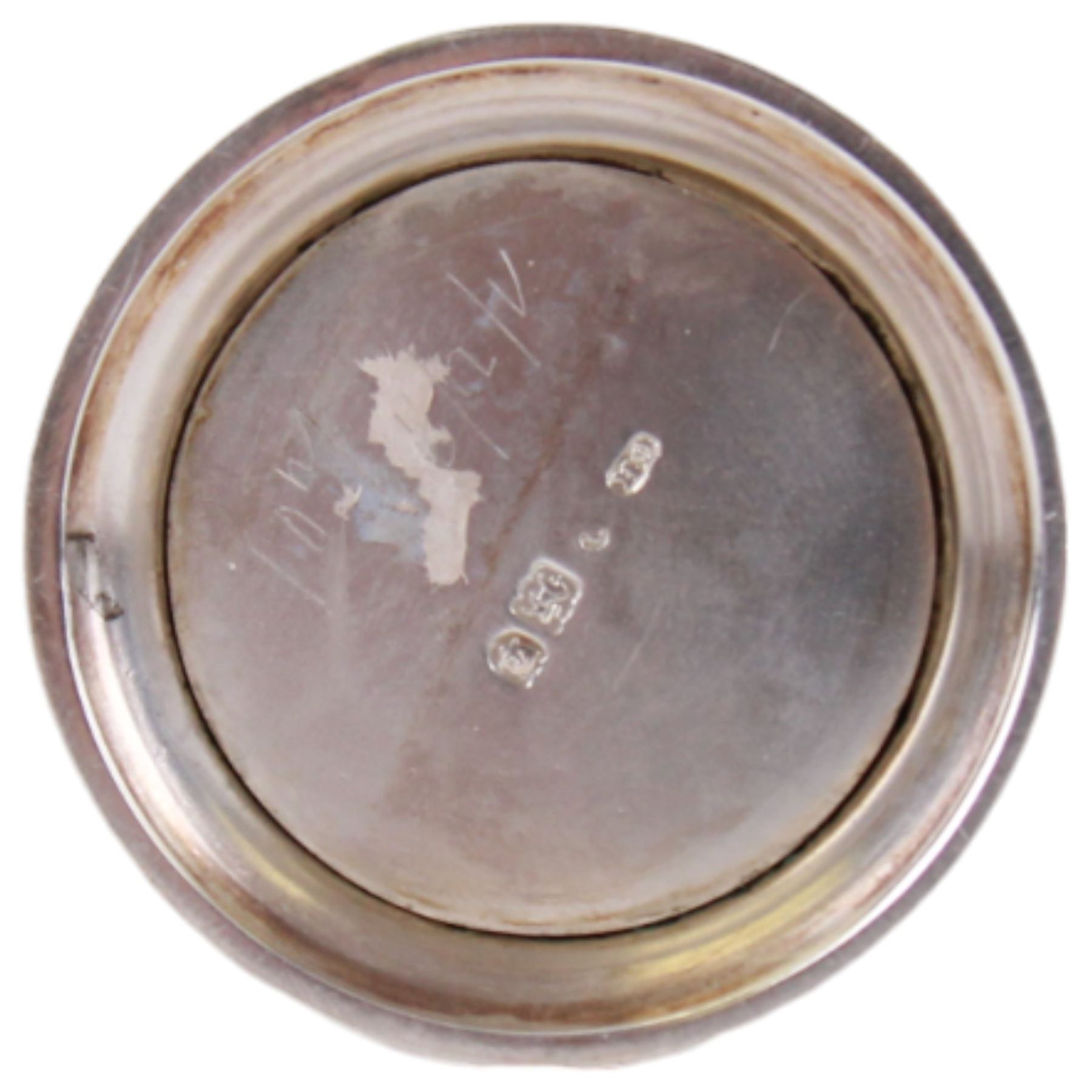 Late Victorian silver pepper, of cylindrical form with screw threaded pierced flat topped cover, the openwork body decorated with flowers of the Union, roses, thistles and shamrocks, revealing a ruby glass liner, upon a spreading circular foot, hallmarked Harrison Brothers & Howson, London 1900, H8cm