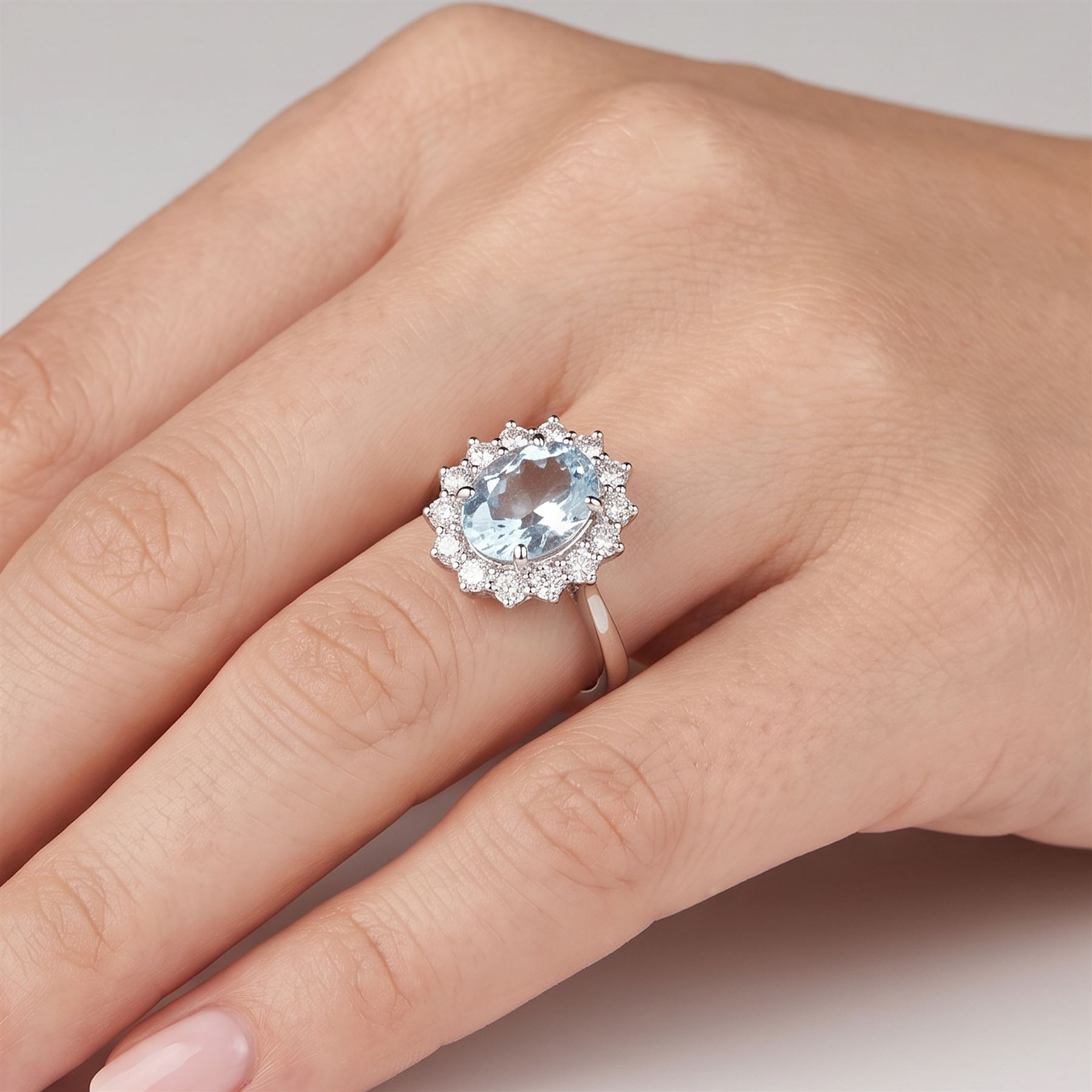 18ct white gold aquamarine and diamond cluster ring, single oval cut aquamarine of approx 2.80 carat, surrounded by fourteen round brilliant cut diamonds, hallmarked, total diamond weight approx 0.60 carat